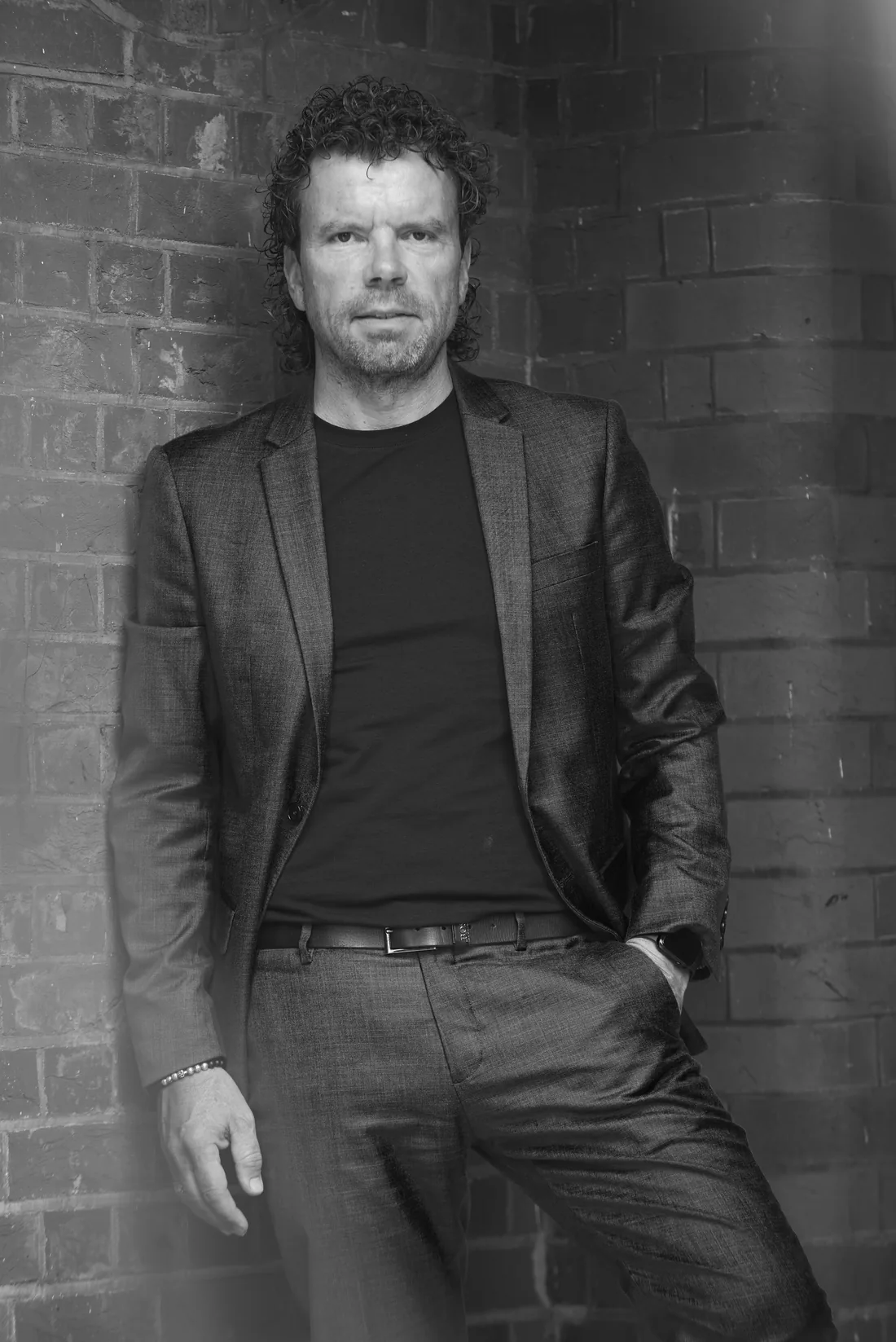 Paul Lorenz, portrait against a brick wall
